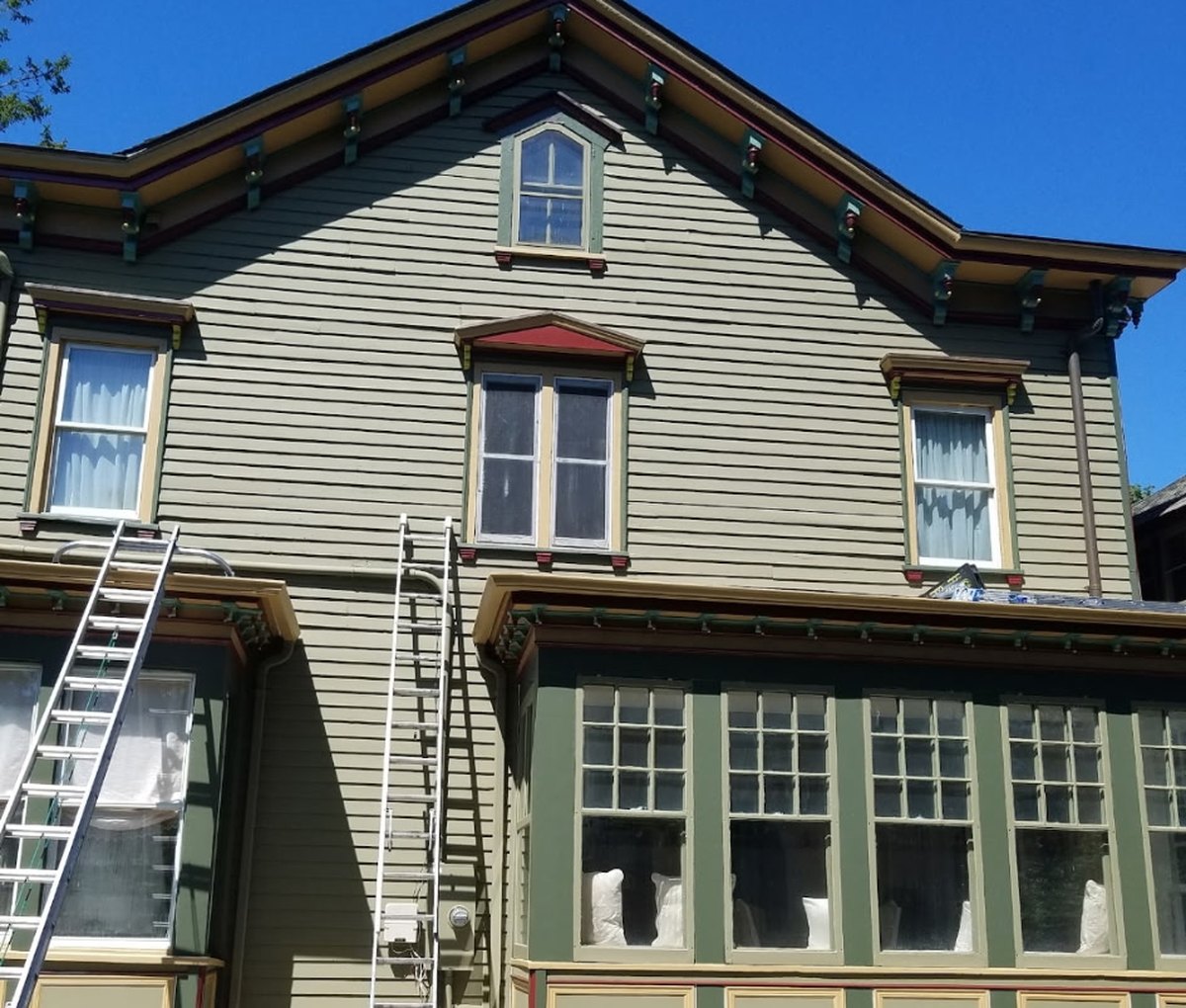 The same Victorian finished in sage green with cream, gold and deep green trim