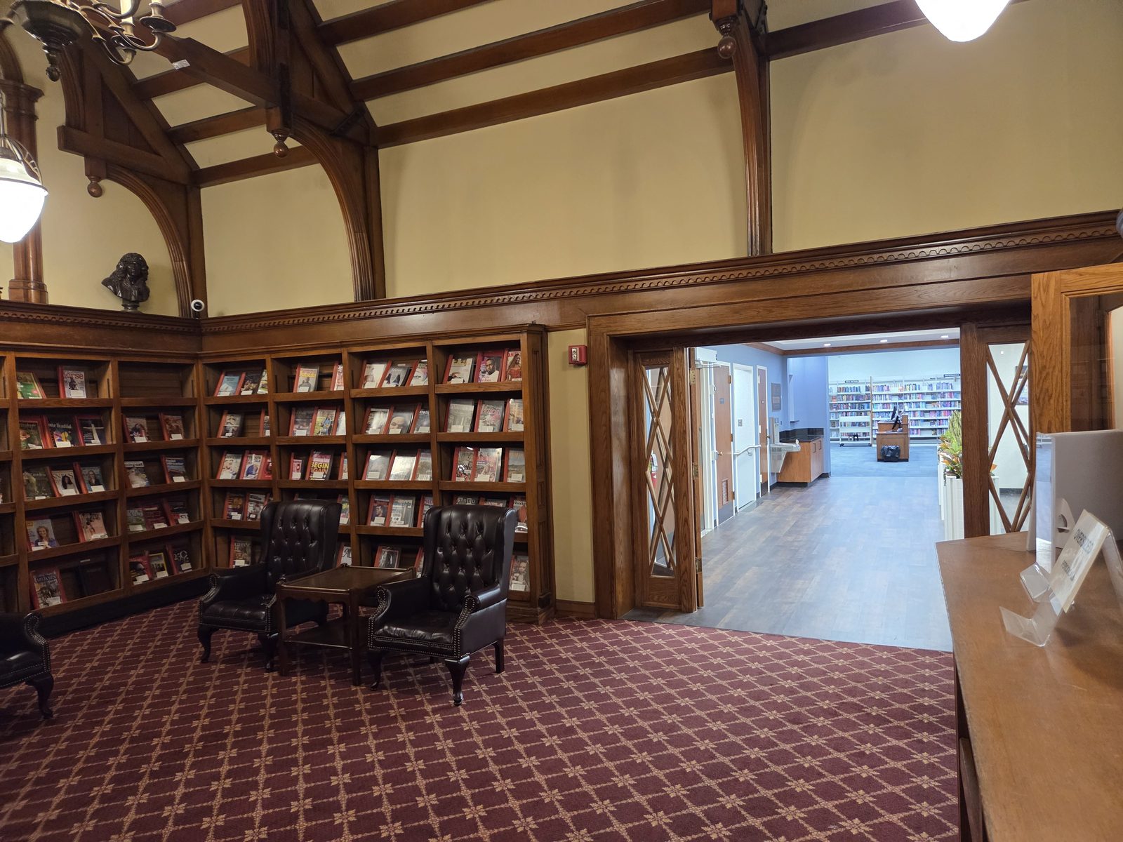 A timber-beamed library with built-in bookcases, repainted around the original woodwork