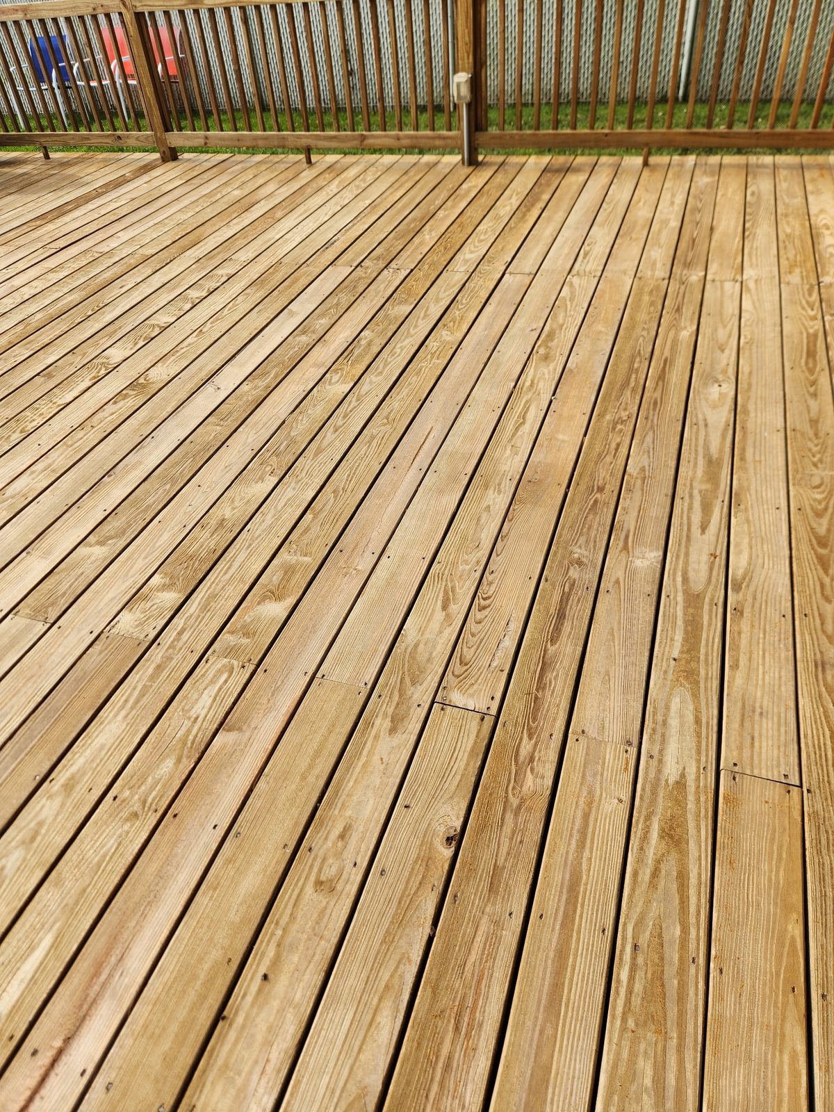 A timber deck sanded back and sealed to a warm golden finish