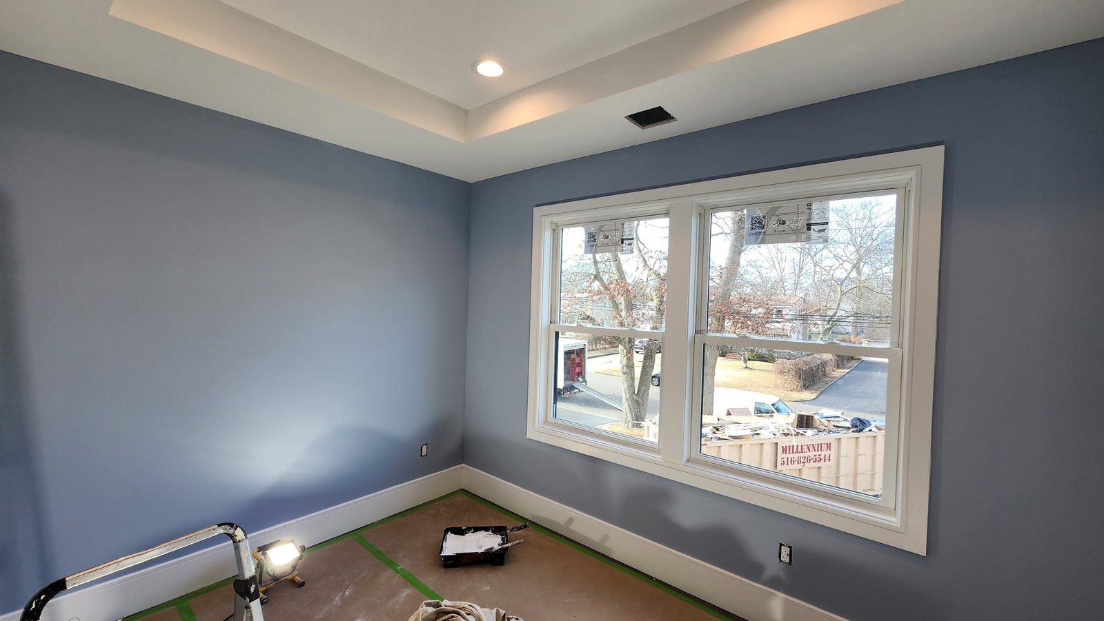 The same room finished in deep blue with white trim and clean edges